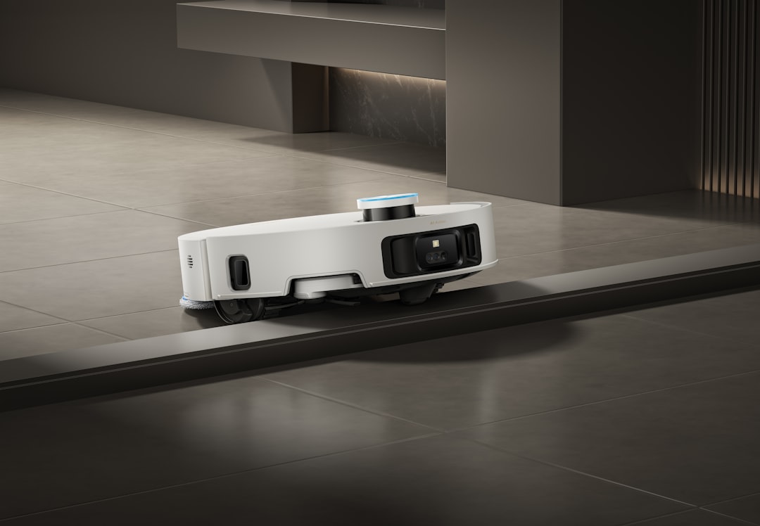 A Dreame robot vacuum and mop climbs over a threshold on tile, showing smart navigation for modern floor care.